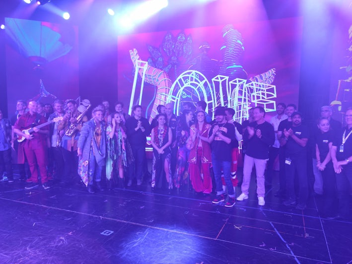 Cast with creative team of Rock Revolution standing together on stage after the performance