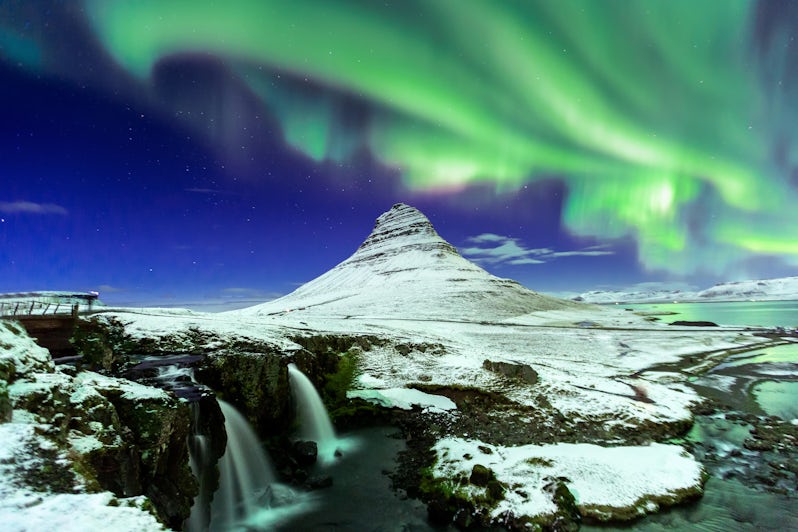 Aurora Borealis showcasing the Northern Lights above Kirkjufell Mountain in Iceland (Photo: basiczto/Shutterstock)
