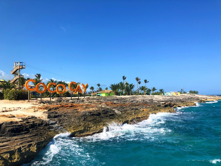 Orange CocoCay sign along the shore at the island's Arrivals Plaza