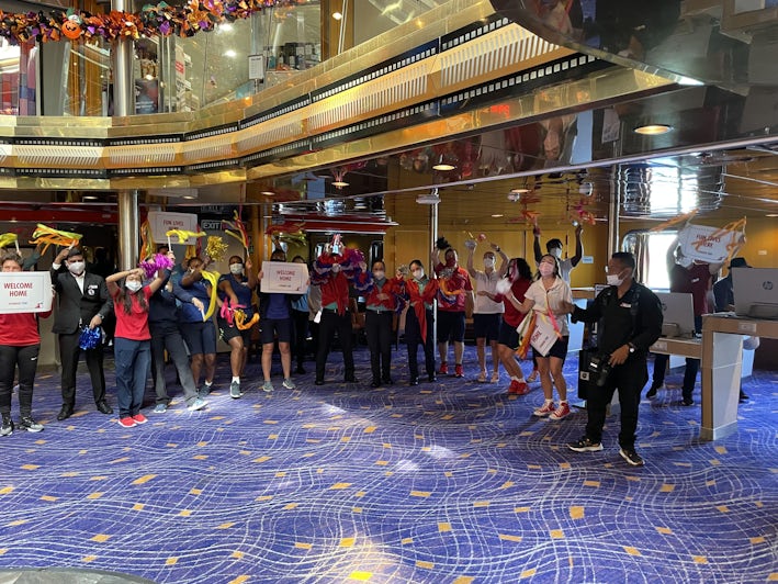 Crew welcome passengers aboard Carnival Ecstasy's final voyage (Photo: Peter Knego)