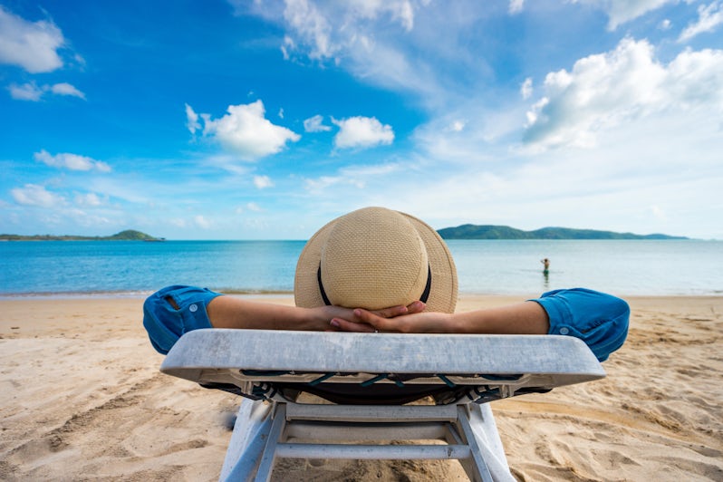 Woman Enjoying Vacation by Beach (Photo: PIXA/Shutterstock)