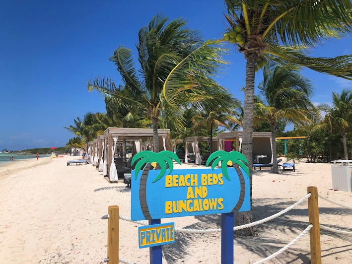 Beach Beds and Bungalows sign with bungalows in the background on CocoCay