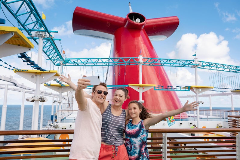 Family Posing in Front of Ships Funnel (Photo: Carnival Cruise Line)