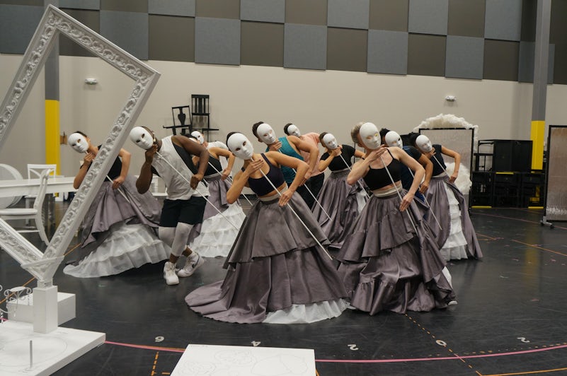 Cast rehearsing Celestial Strings with costumes and masks