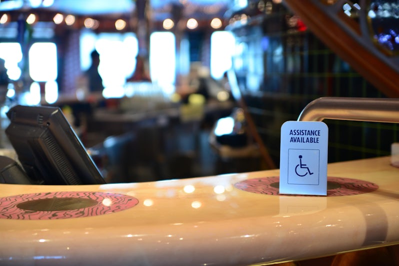 Bar counter and a special needs sign at cruise ship (Photo: Igor_Koptilin/Shutterstock)
