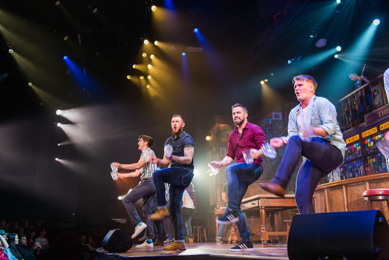 Four male performers dancing onstage for Choir of Man on Norwegian Encore (Photo: Cruise Critic)