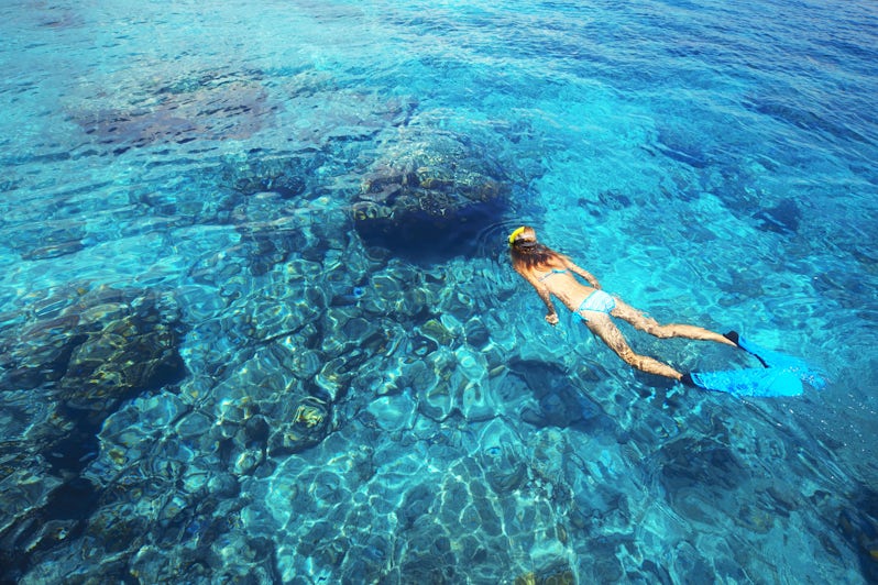 Woman Snorkeling in the Open Clear Blue Waters (Photo: Dudarev Mikhail/Shutterstock)