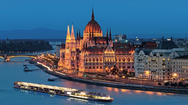 River cruise ship Scenic Jade sails the Danube River past the parliament building in Budapest at night. (Photo: Scenic Cruises)