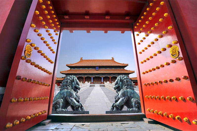 Red entrance gate opening to the forbidden city in Beijing