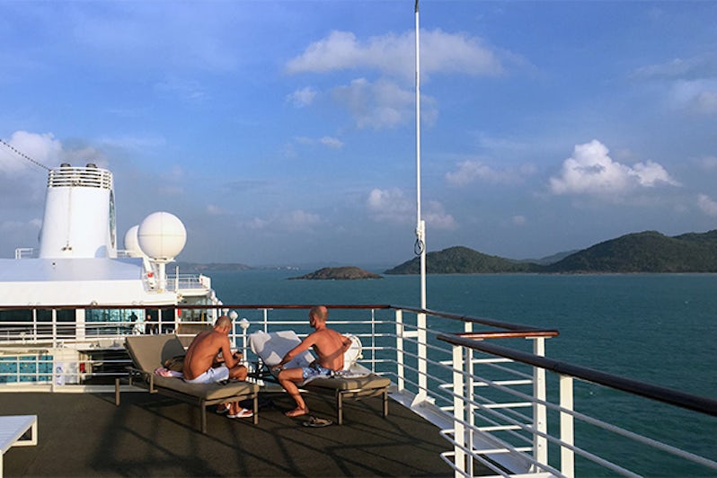 Two men on the top deck of Azamara Quest