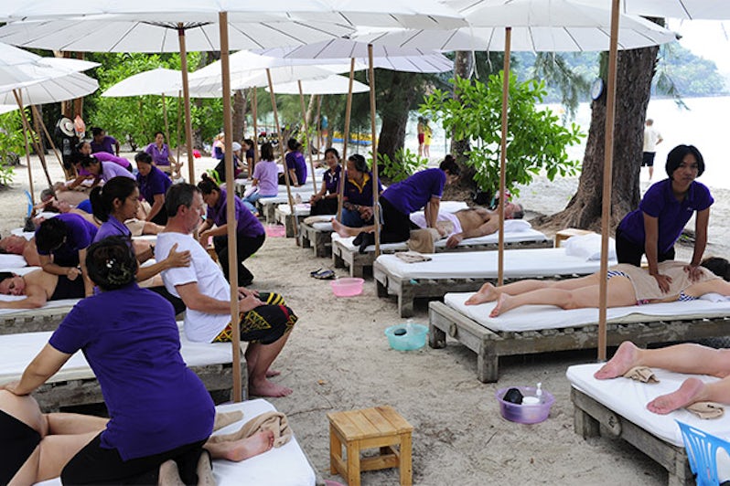 Seabourn passengers getting thai-style massages on the beach