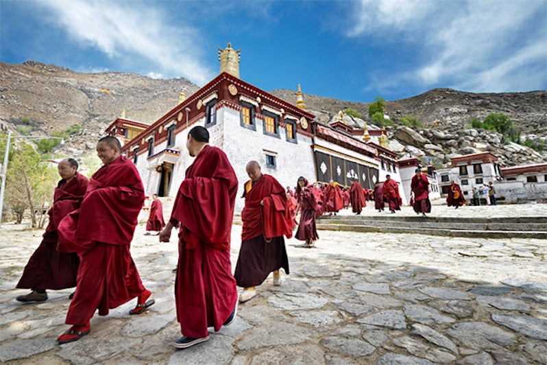 monks leave the main assembly hall of Sera monastery