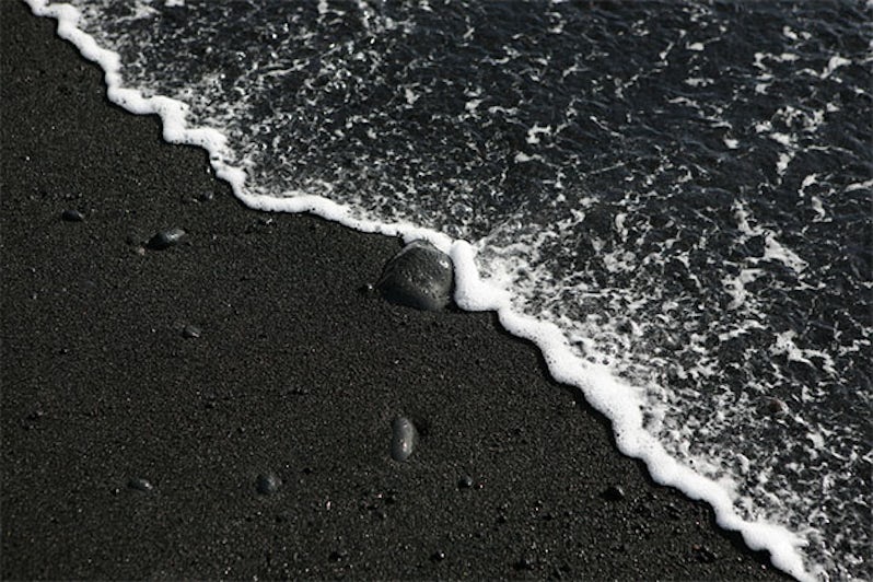 Black sand beach with wave