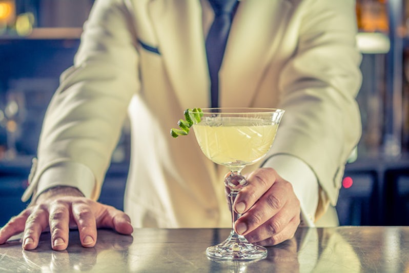 bartender barman serves plain classic rum based drink cocktail lime decoration shaker