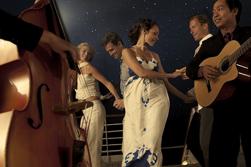 Couples dancing to live music on a Seabourn cruise ship