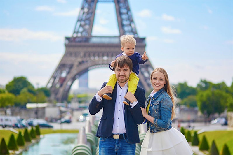 Family of three in front of the Eiffel Tower in Paris