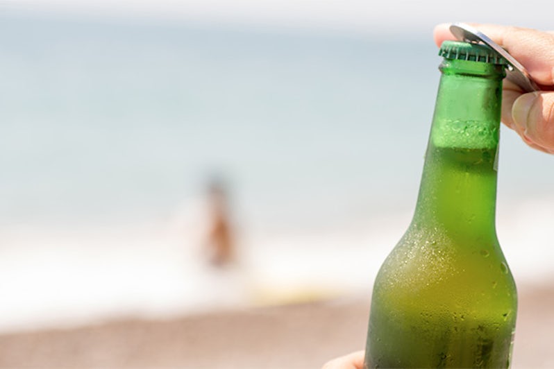 macro photography of a beer with a beach background