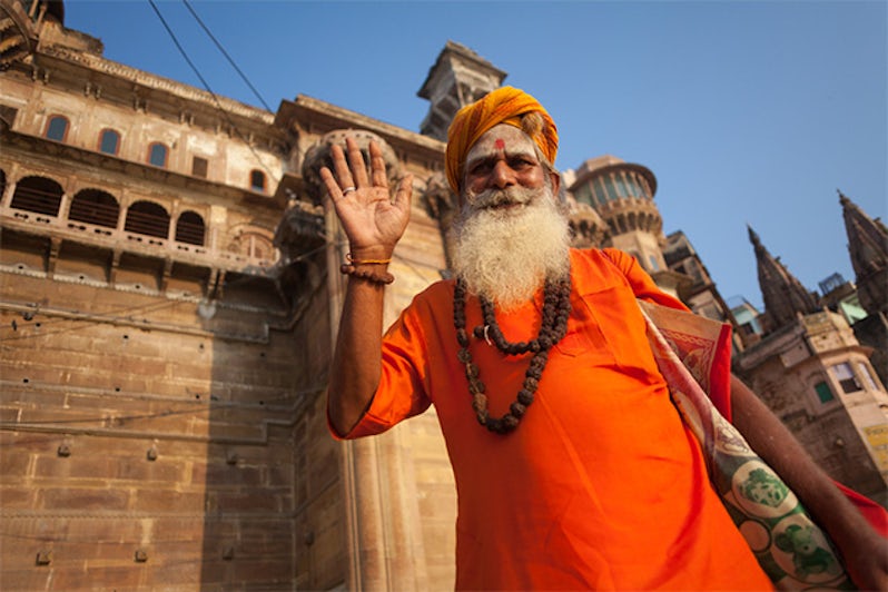 Greetings from an unidentified Hindu sadhu holy man, standing on the ghat near the Ganges river in Varanasi, India