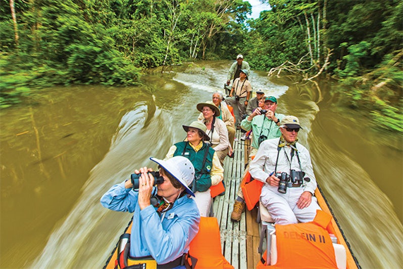 Group of Lindblad passengers on a skiff ride through the Amazon