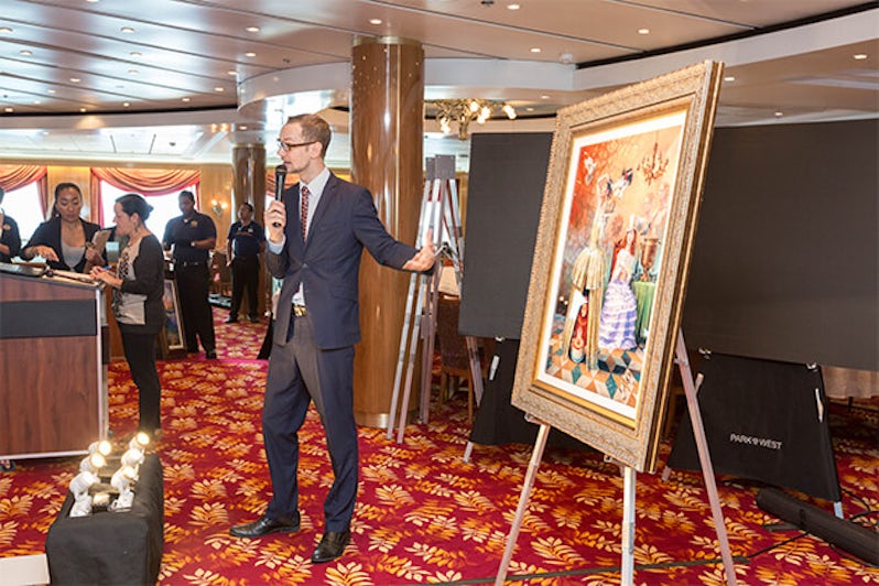 Park West employee holding an art auction on Norwegian Sun