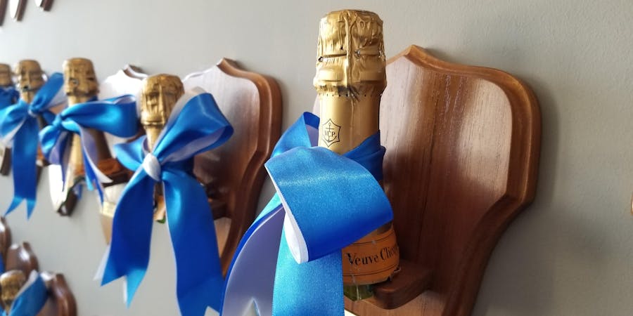 Before Viking started christening its ships with aquavit, it used the traditional Champagne. The bottles are mounted on plaques and hang in the company’s corporate headquarters in Basel (Photo: Colleen McDaniel/Cruise Critic) Before Viking started christening its ships with aquavit, it used the traditional Champagne. The bottles are mounted on plaques and hang in the company’s corporate headquarters in Basel (Photo: Colleen McDaniel/Cruise Critic)