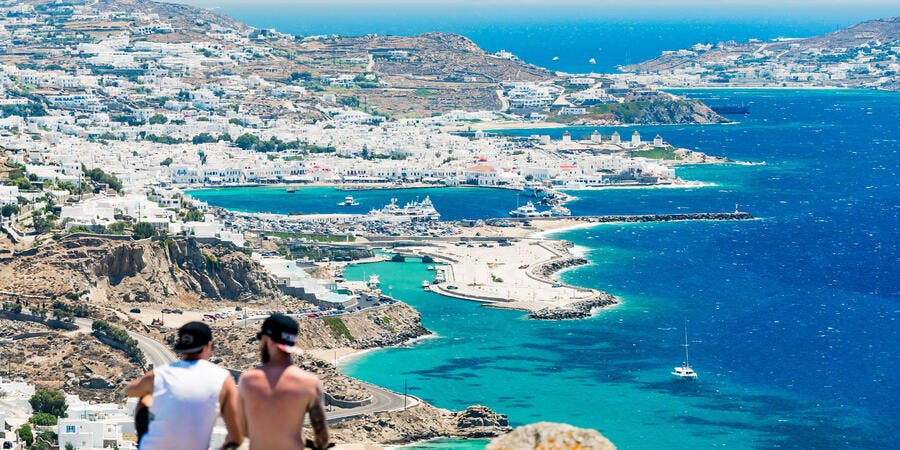 Friends Overlooking on a Mountain in Mykonos, Greece, Europe (Photo: bmphotographer/Shutterstock) Friends Overlooking on a Mountain in Mykonos, Greece, Europe (Photo: bmphotographer/Shutterstock)