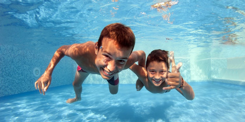 Underwater portrait of two friends having fun in a swimming pool