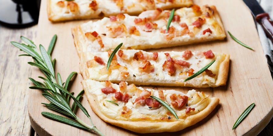 Flammkuchen on Wooden Cutting Board (Photo: Julia Sudnitskaya/Shutterstock) Flammkuchen on Wooden Cutting Board (Photo: Julia Sudnitskaya/Shutterstock)