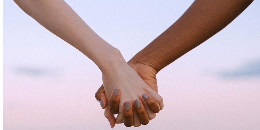 Close-up shot of two women holding hands