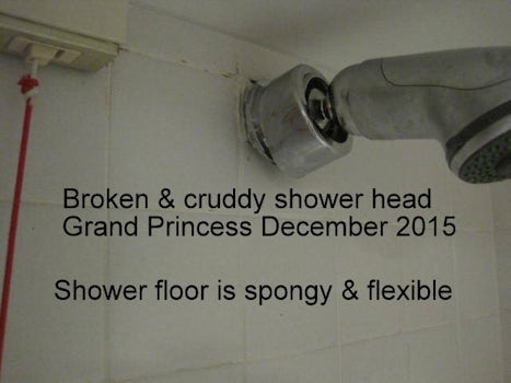 Broken and crudy shower head.  shower floor is spongy and flexible