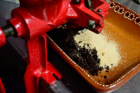 Adding cinnamon and sugar into the ground cocoa beans.