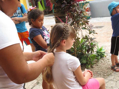 Granddaughter getting her hair braided in Cozumel Port.