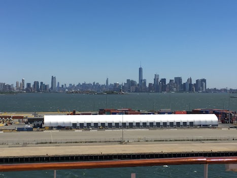 The Manhattan skyline with the Statue of Liberty off the port side while do