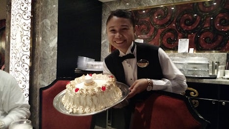Our wonderful assistant waiter presenting our baked Alaska