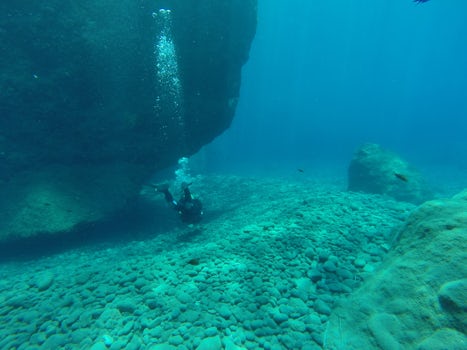 Scuba diving in Santorini - volcanic flow hole caverns dot the coast, but v