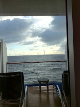 Our veranda w "long chairs, aka chaise lounges. View of wind farm.