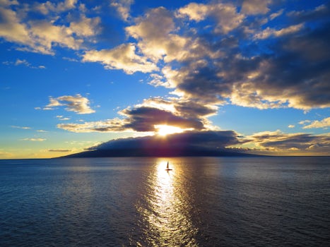 Sunset over Lanai from the ship anchored at Lahaina, Maui.  The clouds over
