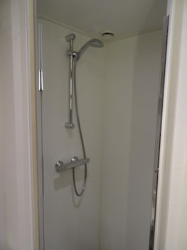 Shower stall with glass door.