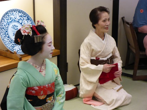 Kyoto - Maiko (apprentice geisha, in green) with her accompanist/escort, ta