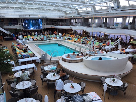 Lido deck. Movie screen in distance. Hot tubs in foreground. Deck above has