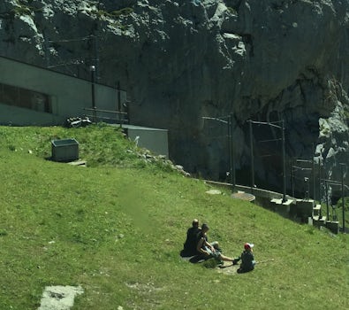 People relaxing on the mountainK