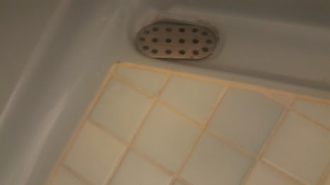 Dirty open drain, outside of the shower.  Floor was dirty too, but that&#39