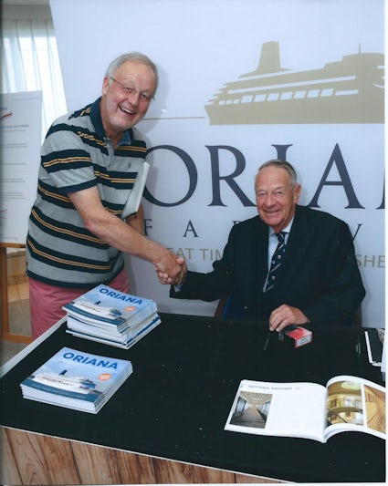 Ian Gibb signing copies of a recently published book on Oriana