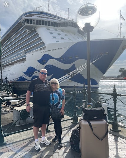 My husband and I returning from our trip - Majestic Princess is in the background and is a huge ship