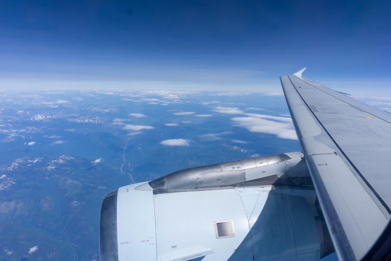 Shot of an airplane in flight, from the airplane window above the wing