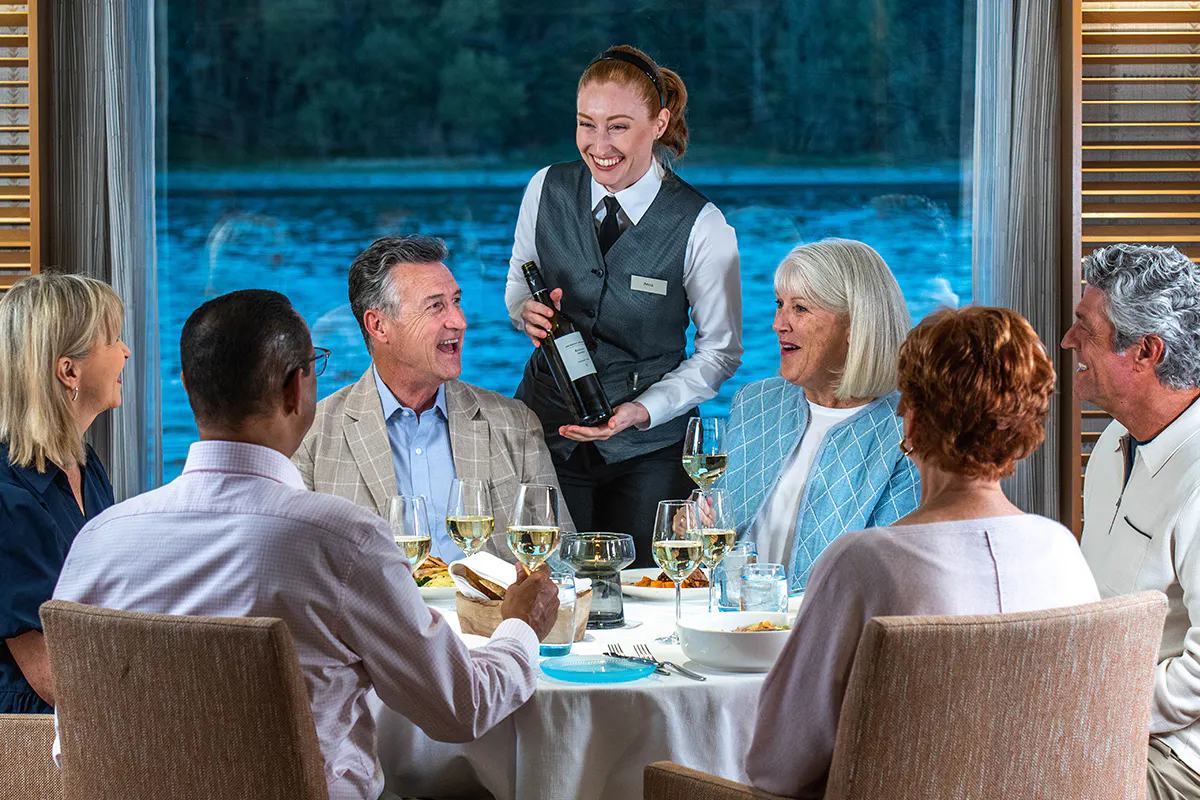 A sommelier in the Restaurant onboard a Viking Longship introduces the wine