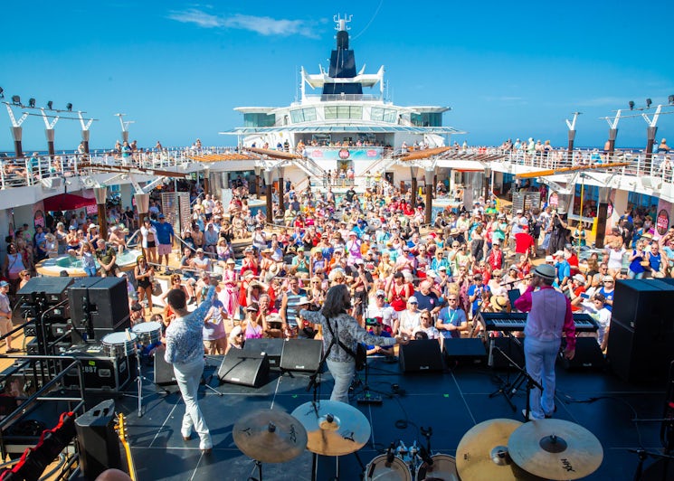 View of the crowd from the stage during a daytime concert on the pool deck during the Ultimate Disco Cruise