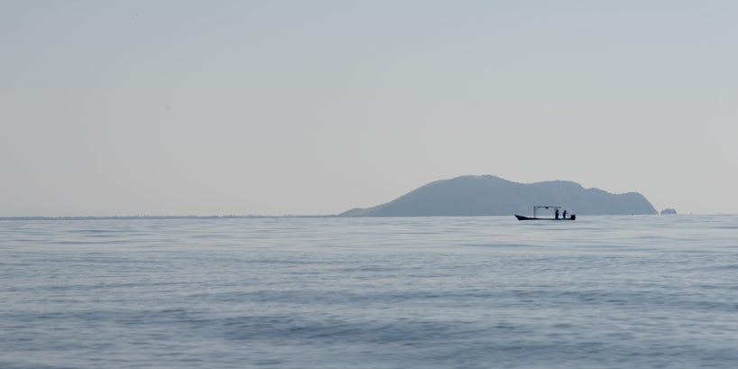 View of fishing boat at sea, Zihuatanejo, Guerrero, Mexico - Photograph by Keith Levit via Shutterstock