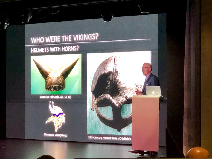 Photo of Viking Jupiter's Resident Historian giving a lecture on Vikings from the onstage theater podium