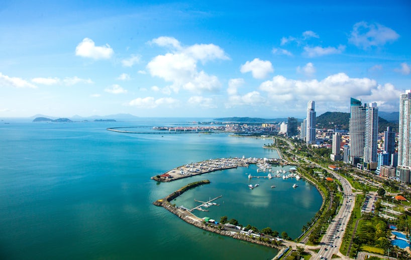 An aerial view of Panama City in Panama, showing skyscrapers and a bay filled with boats.  (Photo: Cris Young/Shutterstock)